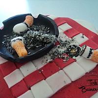 Cigarette on a table cake
