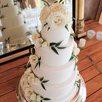 White wedding cake with fresh roses