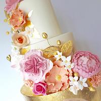 Gold leaf and peachy/pink wedding cake