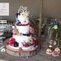 Semi naked weddingcake, with fresh flowers and fruits