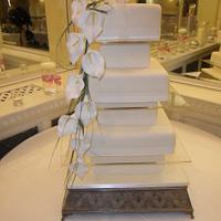 6 tier ivory wedding cake with orchid spray