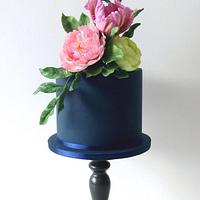 Navy blue one tier cake with sugar flowers