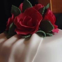 Drapes and roses wedding cake