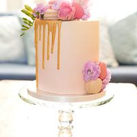 Delicate pink watercolour ombré birthday cake with gold drip, fresh flowers and macarons