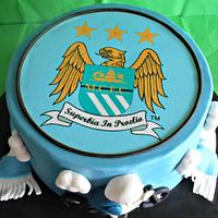 Man City and cycling themed cake 