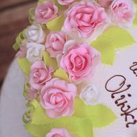 cake decorated with cream and sugar roses