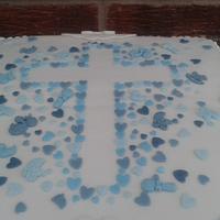  Christening cake with stencil cross and scattered heart confetti
