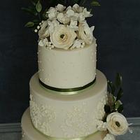 Cream and olive ranunculus wedding cake