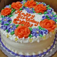 Coral and purple buttercream flowers on cake