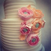 White wedding cake with Ranunculus flowers