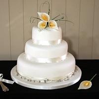 Simple wedding cake with sugar lilies