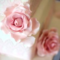 Pink roses and edible lace wedding cake
