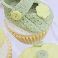 Knitted baby booties and buttons cupcakes 