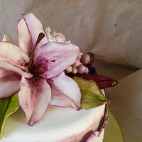 Purple cake with lily and roses.