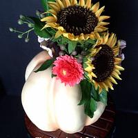 Thanksgiving pumpkin cake with sunflowers and mums