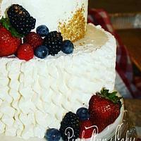 A gold berries and cream wedding cake