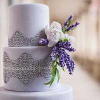 Wedding cake with lace , lavender and tulips