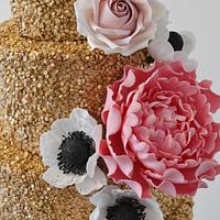 Huge gold cake with sugar flowers