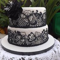 White and black hand piped wedding cake 