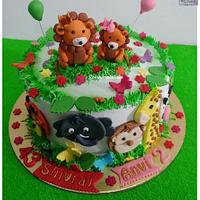 A Cute Jungle theme cake with Simba and animals on it