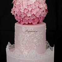 Wedding lace cake in pink with blue bow and hortensias
