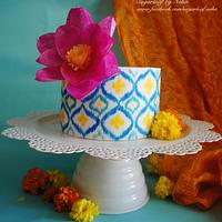 Hand-painted Ikat pattern cake with stylized wafer paper lotus