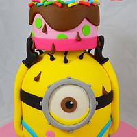 Minion balancing a birthday cake on his head!