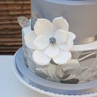 Wedding cake with marble fondant and magnolias