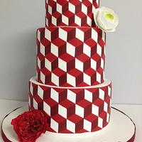 Modern red and white cake with geometric patterns.