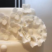 White wedding cake based on Justin Alexander dress