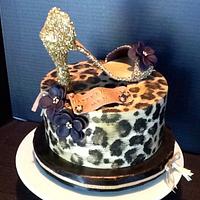 Leopard print cake with gold sparkly shoe and cupcake tower