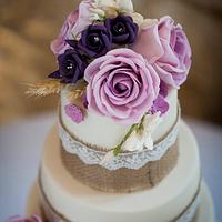 Hessian, lace and rose wedding cake and accompanying bride and groom topper 