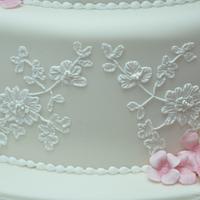 Customised piped lace wedding cake taken directly from wedding dress