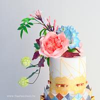 Gold cake with origami and flowers