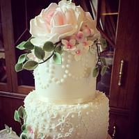 Vintage lace and rose wedding cake with snowberries  