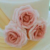 pink roses and gold sashes 4 tier wedding cake