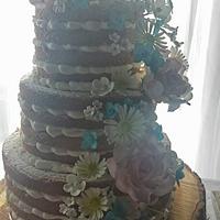 3 tier naked wedding cake with sugar flowers.