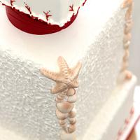 Red and white beach wedding cake