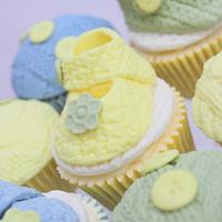 Knitted baby booties and buttons cupcakes 