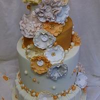 cream gold and peach tiered wedding cake 