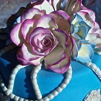 Blue vintage wedding cake with pink edged sugar roses
