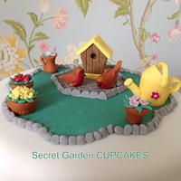 Garden Theme Cake with birdhouse, robins, hedgehog, freesias, daffodils, ladybirds and more