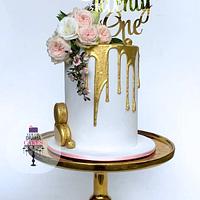 Gold drip cake with fresh flowers