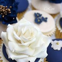 a royal blue and lace wedding cake and cupcakes 