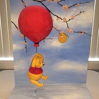 Winnie the Pooh floating from balloon