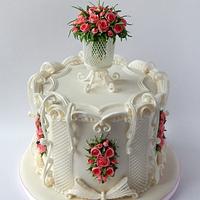 Cake with a bouquet of roses in an openwork vase