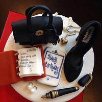 Birthday cake with Mulberry bag Chanel shoe pearl earrings and necklace and an agenda
