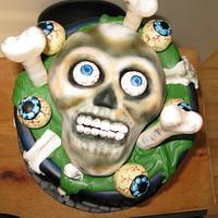 skull cake  in cauldron cake and cake pops eyes