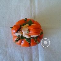 Halloween baby on a pumpkin 