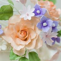 Ivory wedding cake with pastel flowers